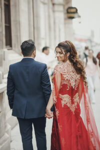 beautiful-woman-long-red-dress-walks-around-city-with-her-husband_1157-13391